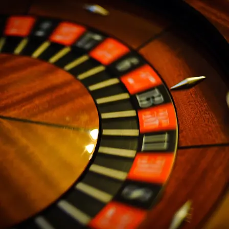 A roulette wheel photographed mid-spin, the ball still running in the outer track